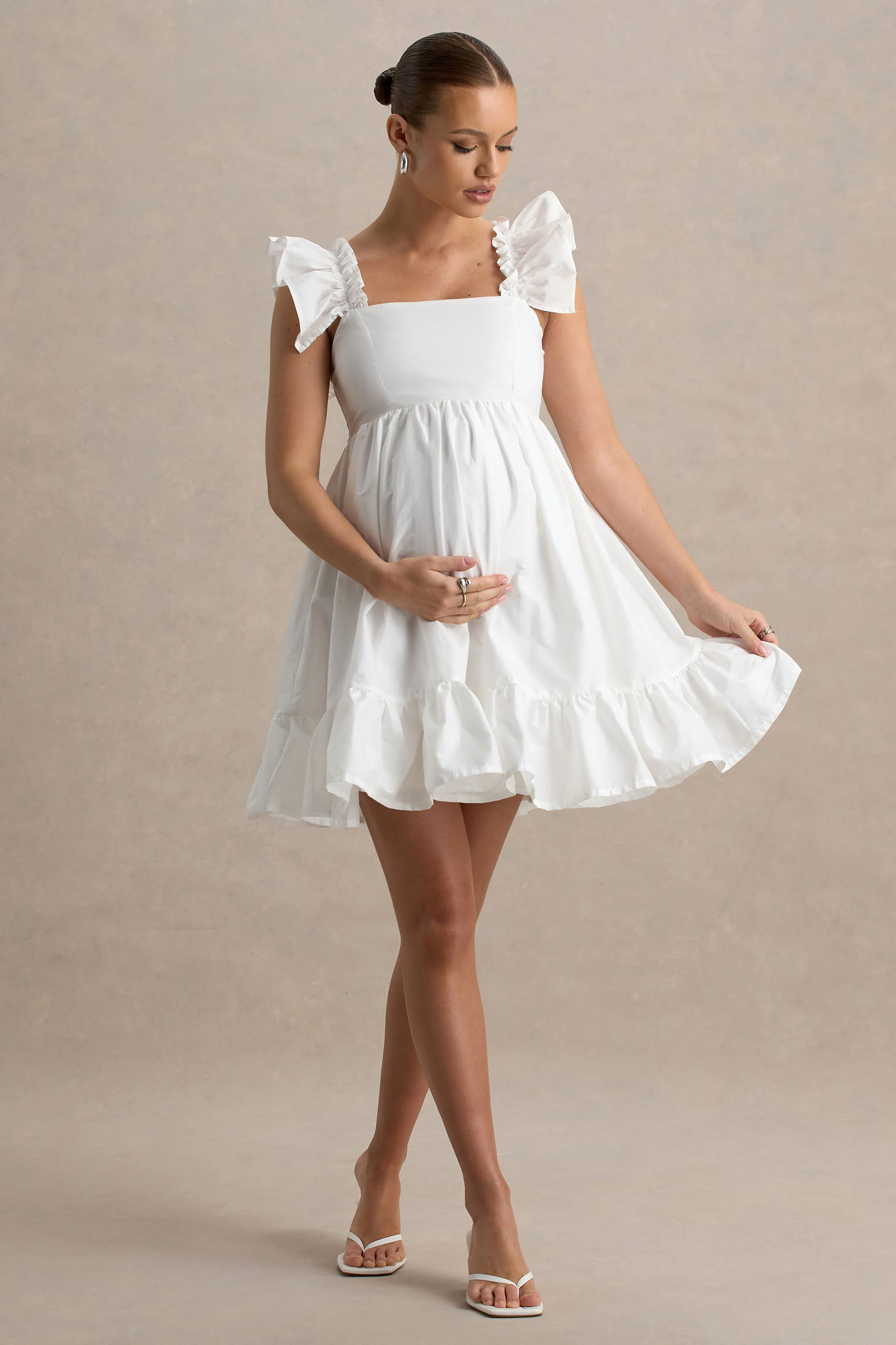 17174-dolly-daze-white-ruffle-sleeve-babydoll-maternity-mini-dress-1.webp