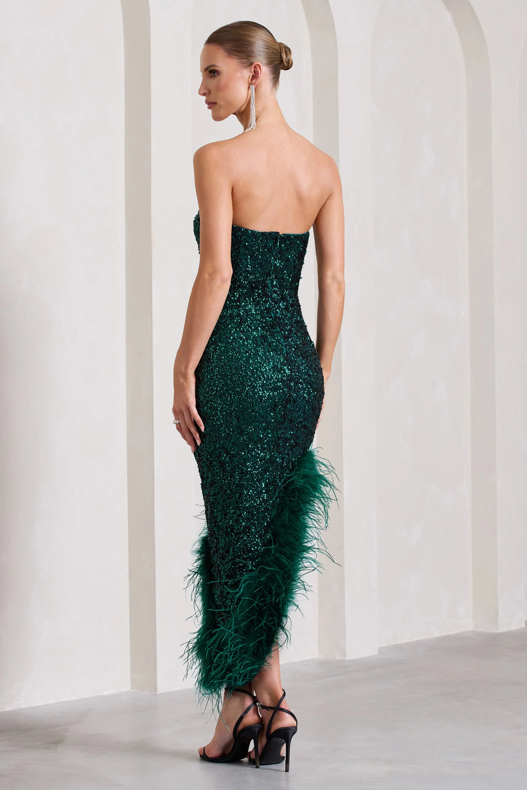 1860-emulate-bottle-green-sequin-asymmetric-bandeau-maxi-dress-with-feathers-1.webp