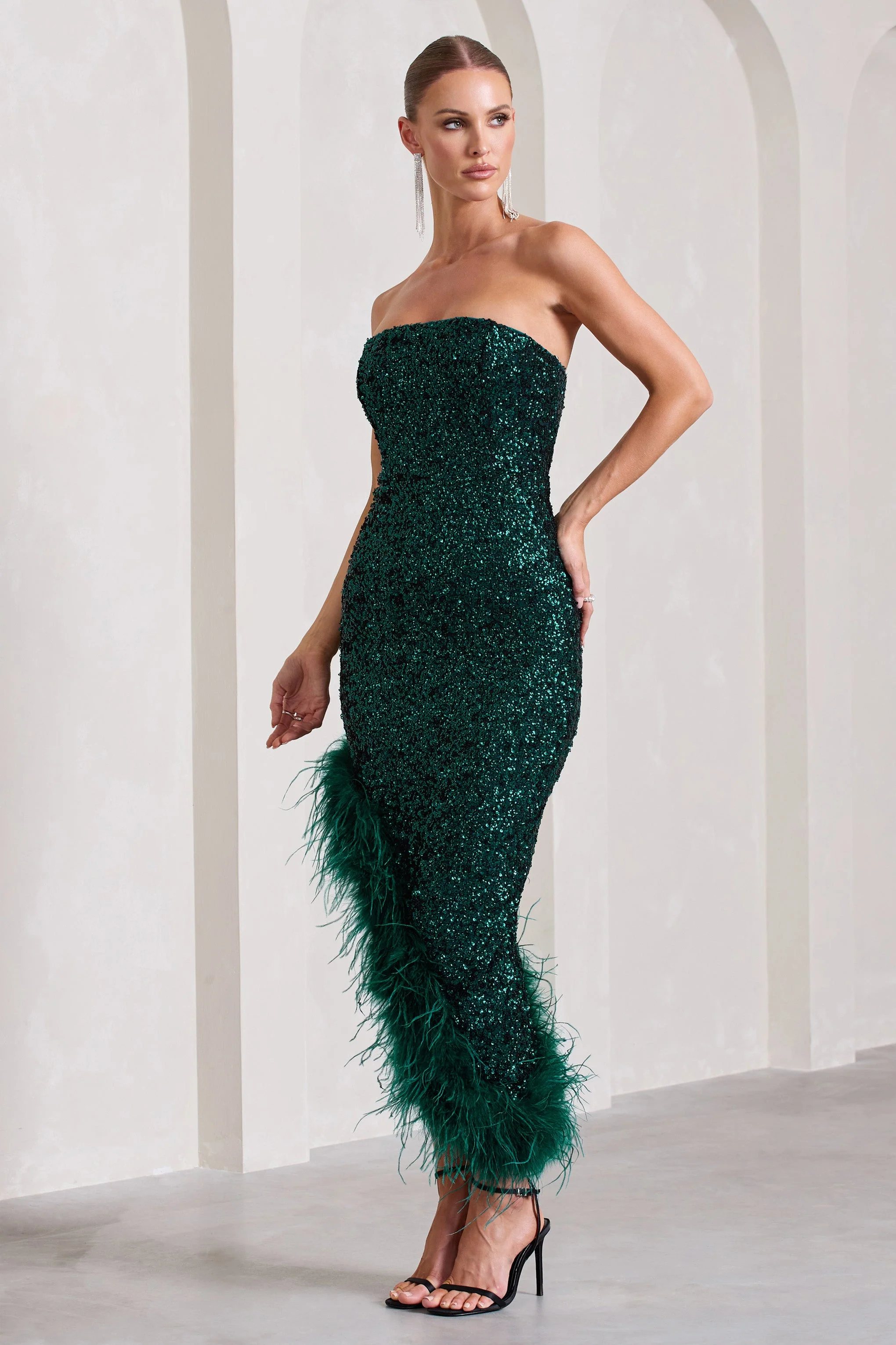 1860-emulate-bottle-green-sequin-asymmetric-bandeau-maxi-dress-with-feathers-1.webp