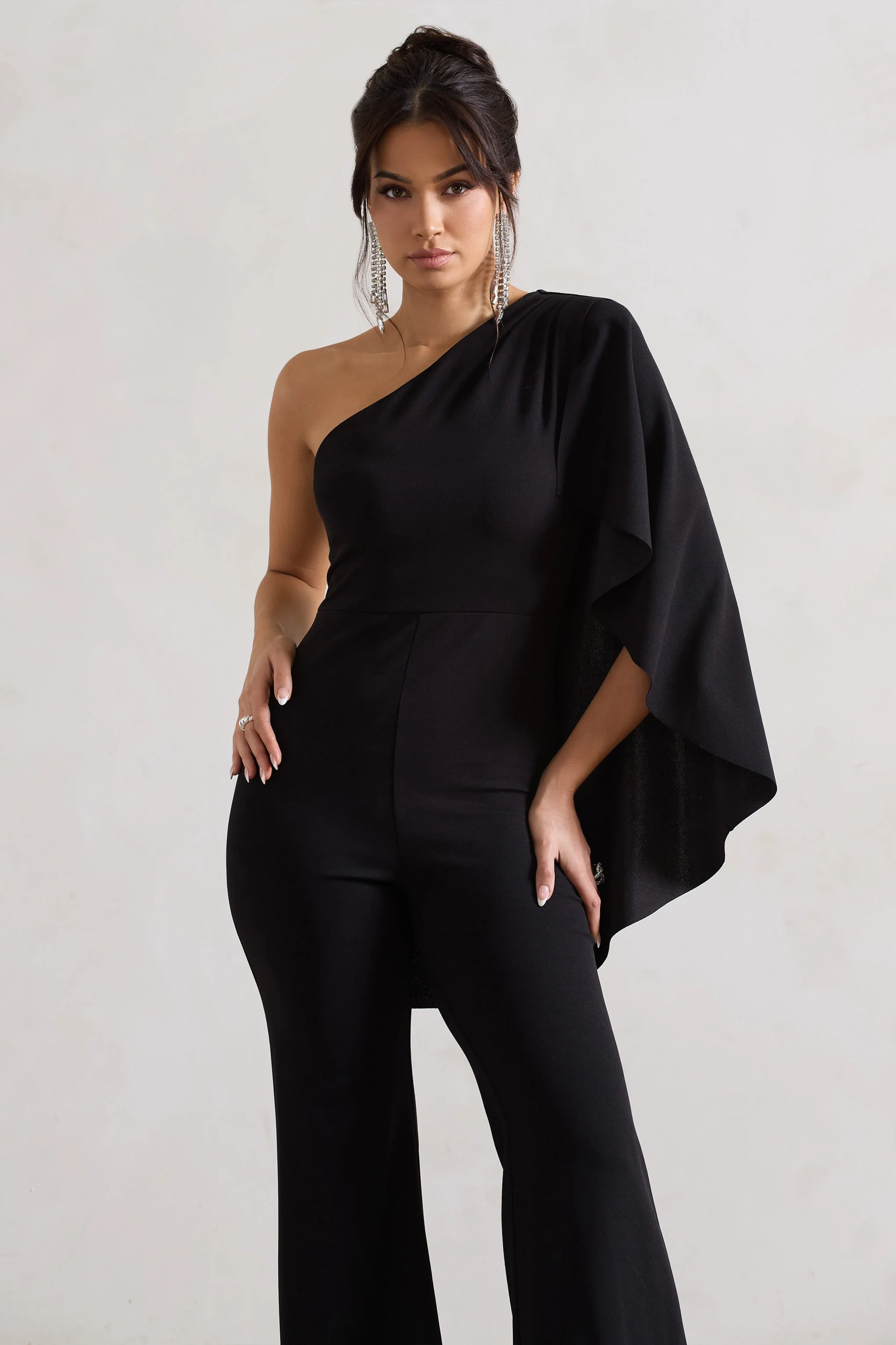 20604-pristine-black-one-shoulder-cape-sleeve-flared-leg-jumpsuit-1.webp
