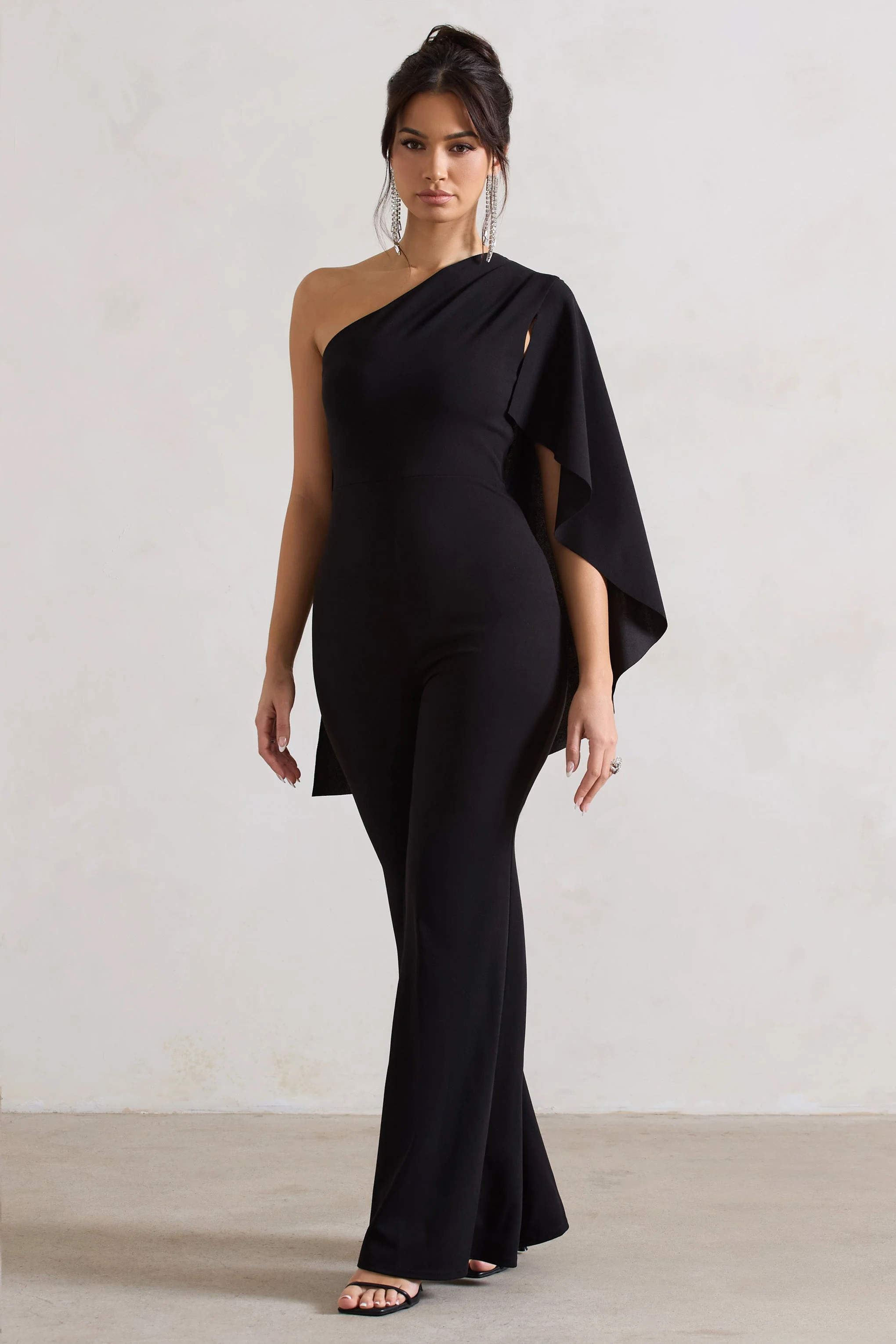 20604-pristine-black-one-shoulder-cape-sleeve-flared-leg-jumpsuit-1.webp