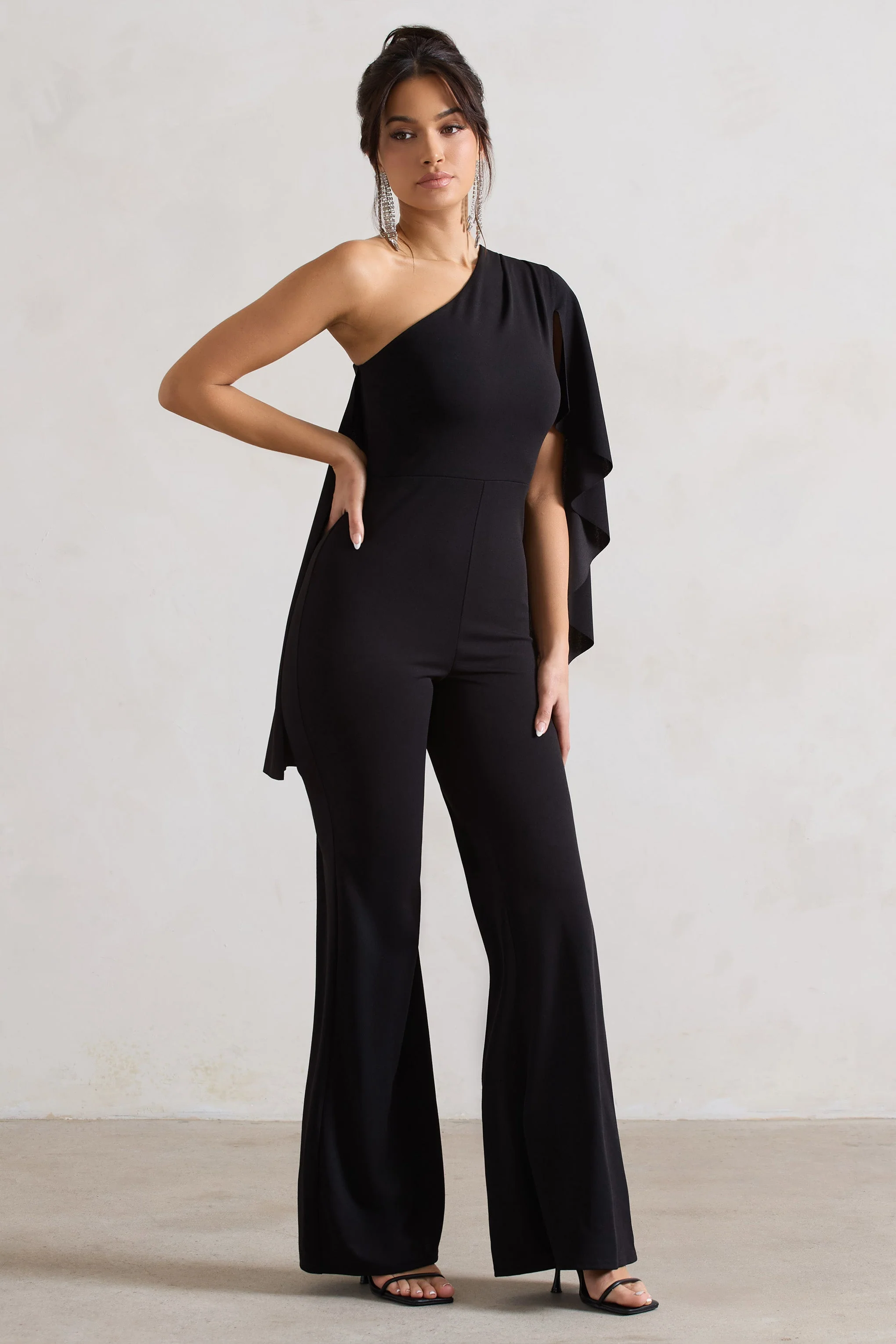 20604-pristine-black-one-shoulder-cape-sleeve-flared-leg-jumpsuit-1.webp