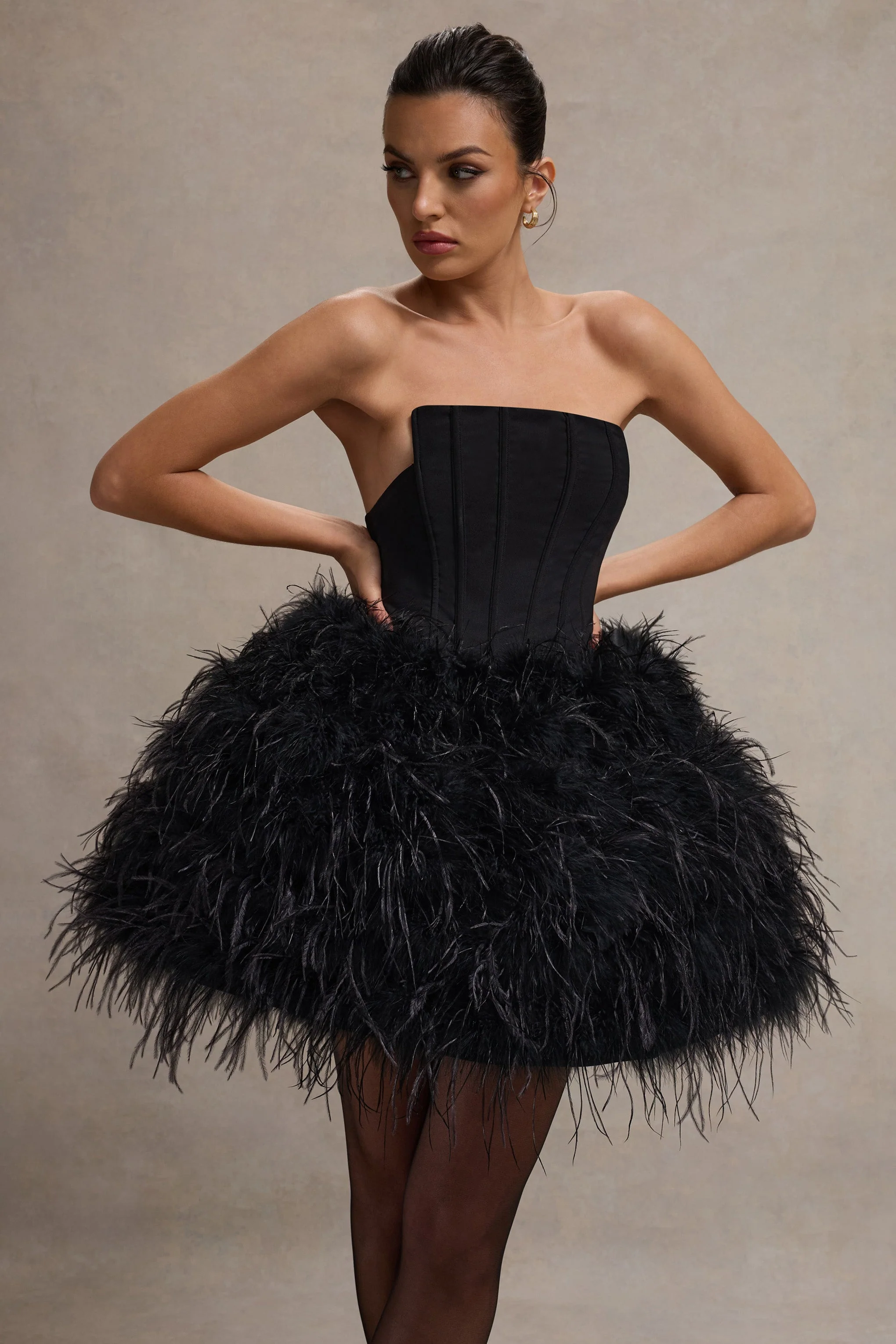 7613-peaches-black-strapless-mini-dress-with-volume-feather-hem-1.webp